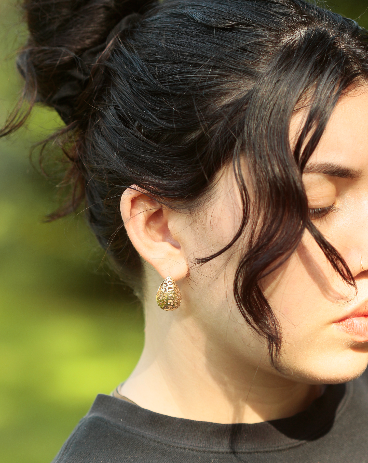 girl wearing gold hoop earrings with leopard print cutouts