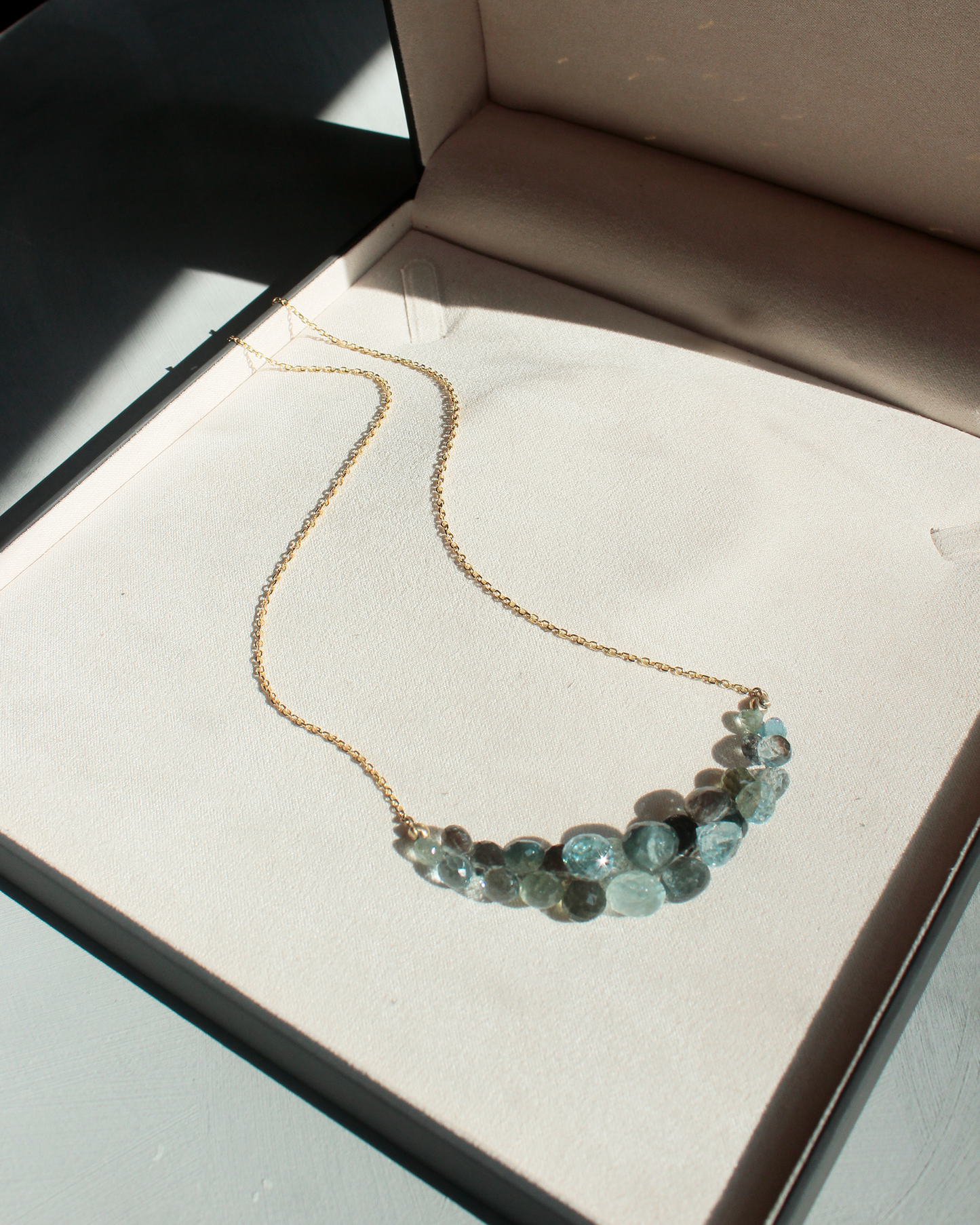 gold necklaces with blue green faceted beads