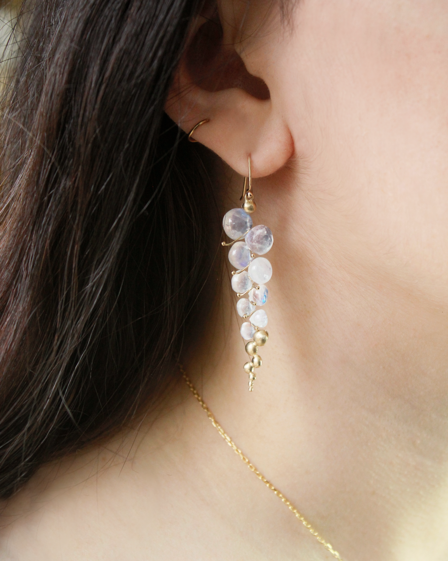 woman wearing moonstone drop earrring