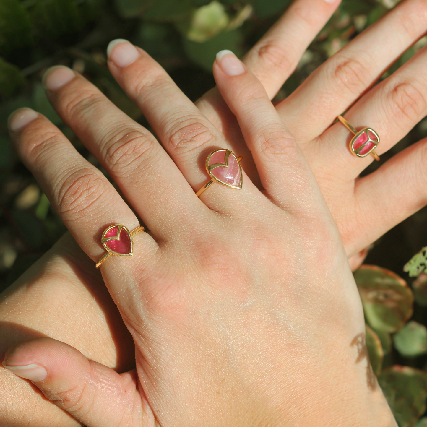 Woman modeling 3 pink and gold rings