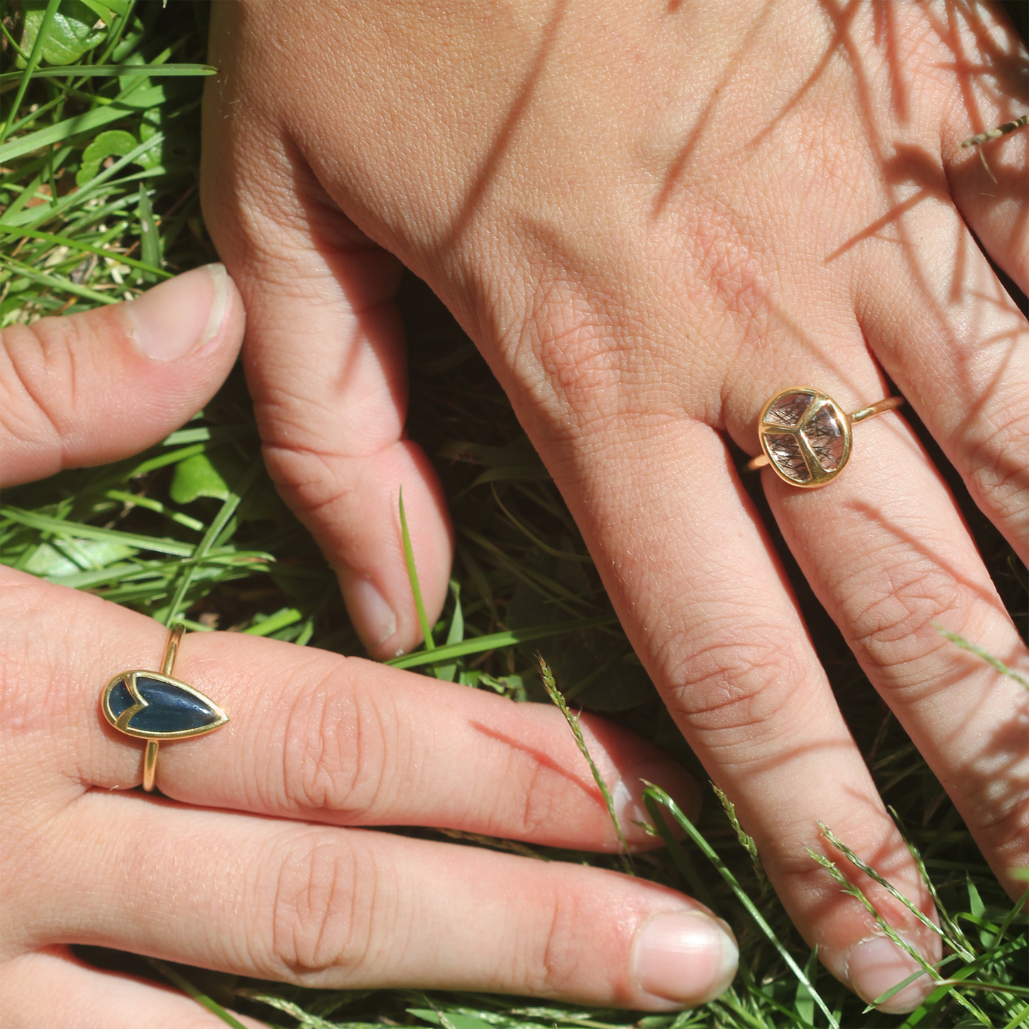 Woman Modeling Yellow Gold ring with bezel set, oval-shaped, rutilated quartz stone, with gold beetle wing detail