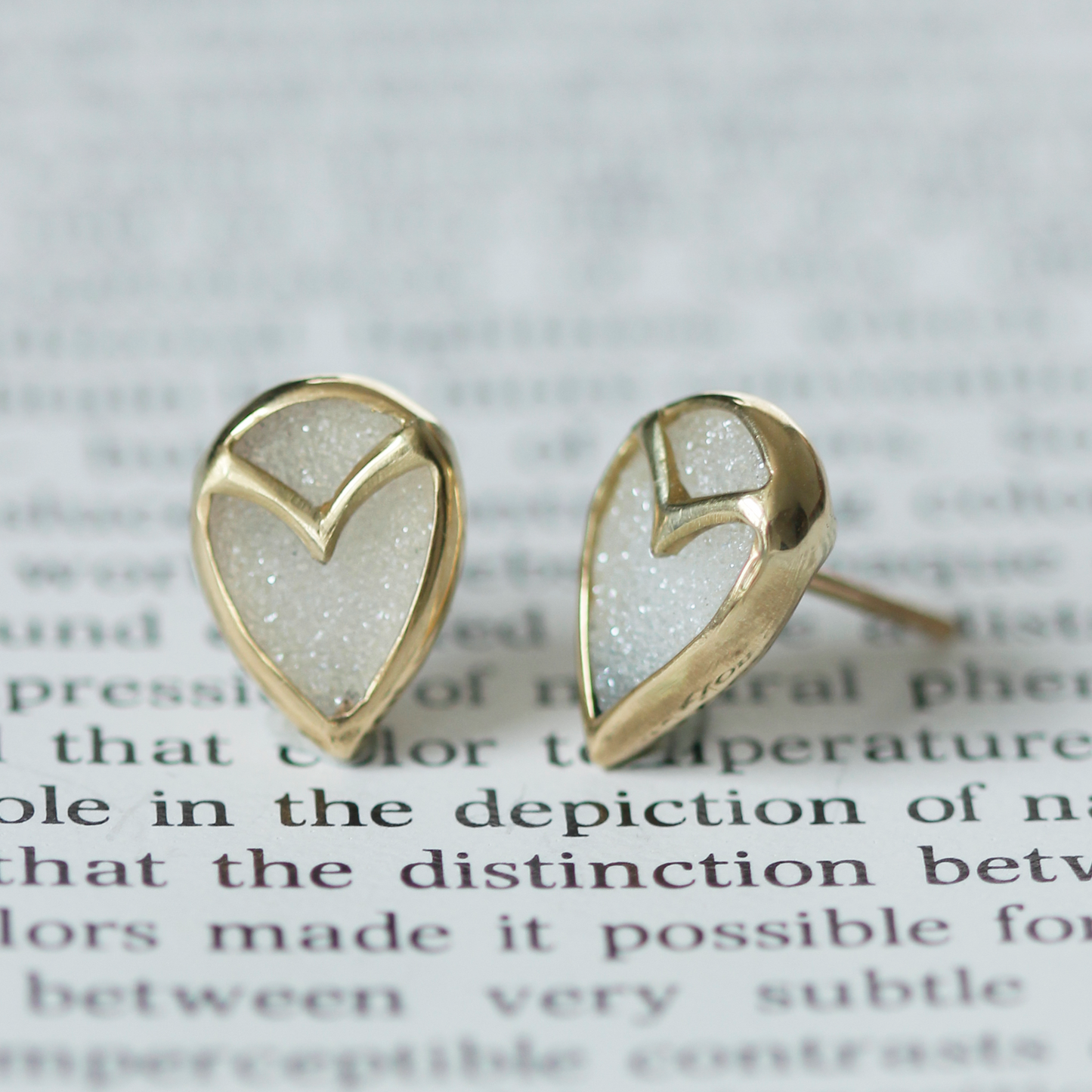 Upside-down tear shaped earrings in yellow gold, with bezel set white druzy quartz and subtle owl beak detail