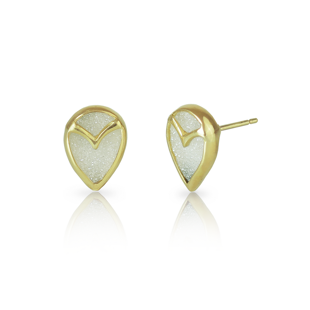 
                  
                    A pair of stud earrings with teardrop-shaped, white druzy quartz stones, bezel set with yellow gold owl beak detail
                  
                
